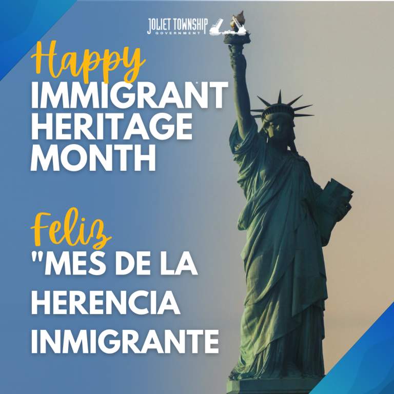 The statue of liberty stands tall in the background. It is a green metal statue of a woman in robes, a spiked crown, and she holds a flame up in one hand and a tablet of text in another hand. Text reads "Happy Immigrant Heritage Month" in English and Spanish.